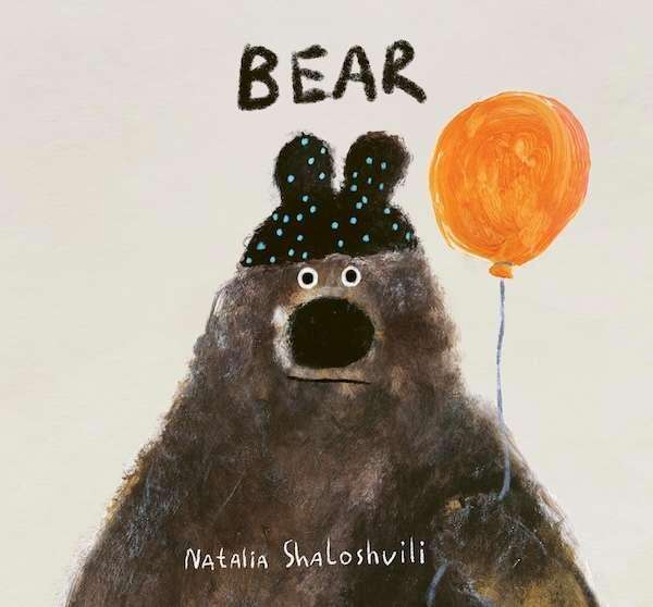 Charming illustration of a bear holding an orange balloon, wearing a black hat with blue spots—perfect for picture books about communication. "BEAR" appears above, with "Natalia Shaloshvili" at the bottom.