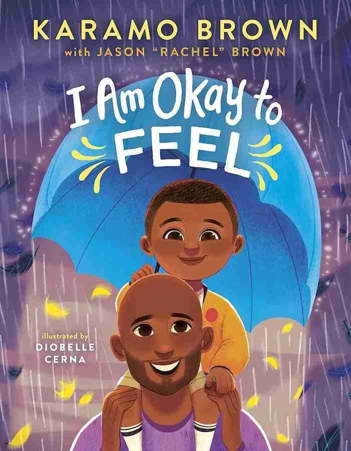 The book cover of "I Am Okay to Feel" by Karamo Brown with Jason "Rachel" Brown, illustrated by Diobelle Cerna, beautifully captures the essence of books about fathers, featuring an adult and child under a colorful umbrella.