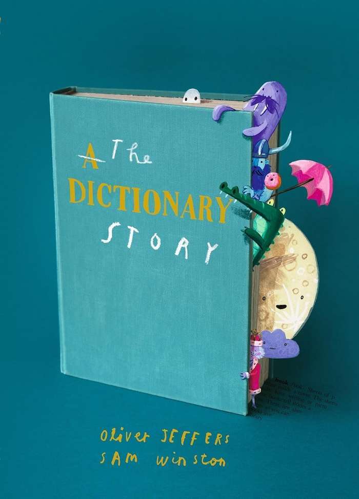 A teal book titled "The Dictionary Story" features colorful illustrations of whimsical creatures and objects, like an umbrella and moon, peeking out from its pages—a charming addition to picture books about communication by Oliver Jeffers and Sam Winston.