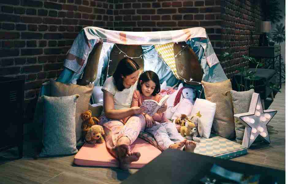 Mother and Daughter Reading Books in a Tent